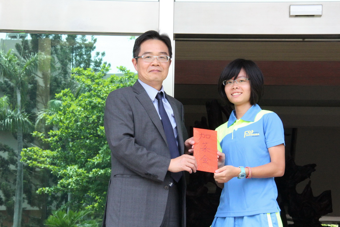 校長致贈加菜金給代表隊由田徑隊仝玉潔同學代表接受